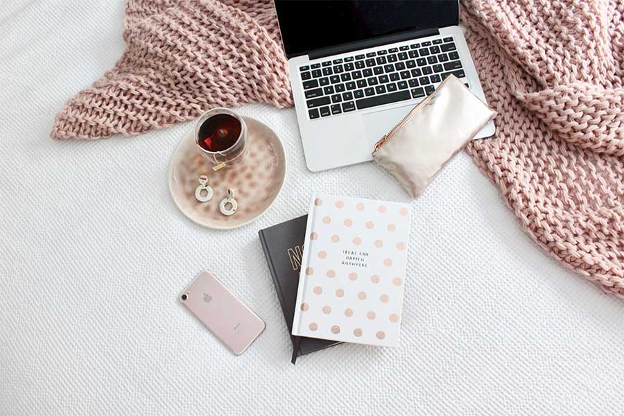 Picture of Phone, Laptop, Coffee, and Notebooks on Bed - Email Marketing Post